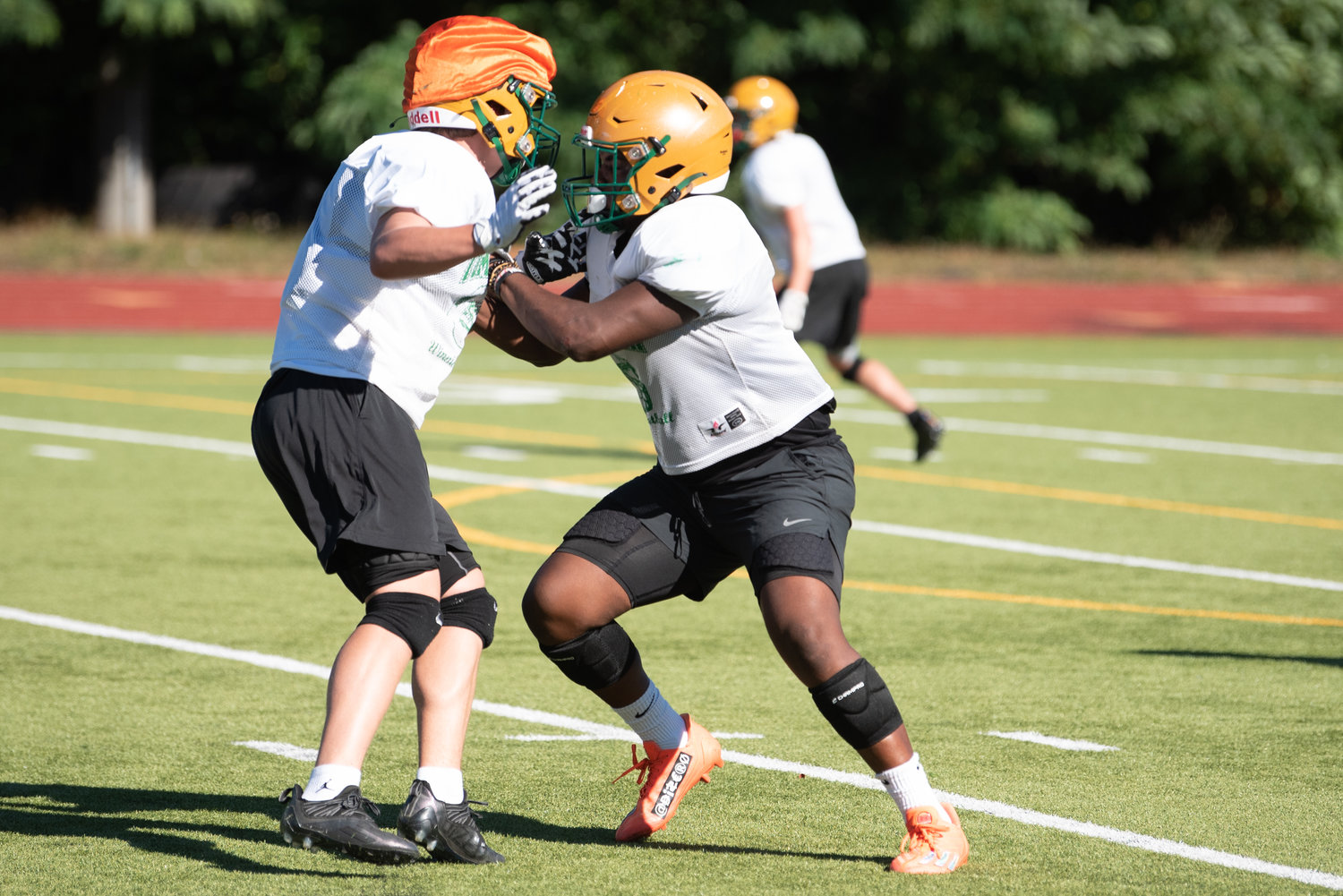 Tumwater's Carlos Matheney takes on a blocker during the T-Birds' practice on Aug. 22.